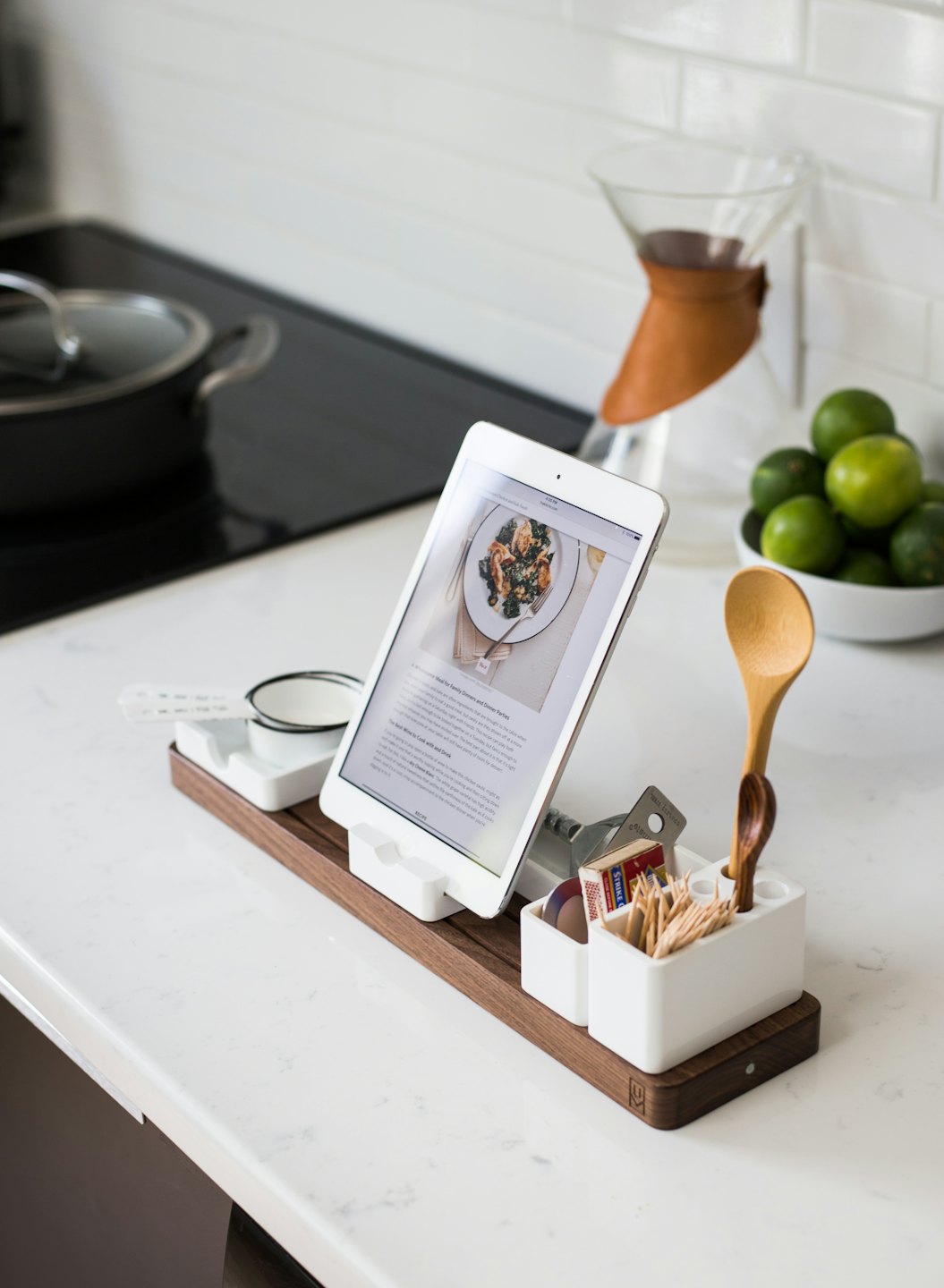 Kitchen counter with iPad recipe, coffee maker, and limes.